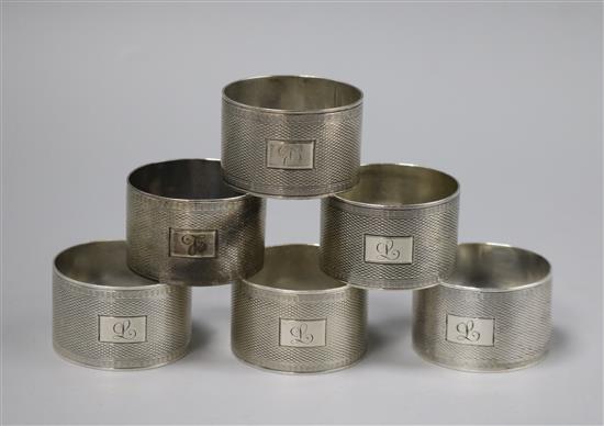 A set of six engine turned silver napkin rings, H.F. Withers, 1945/6.
